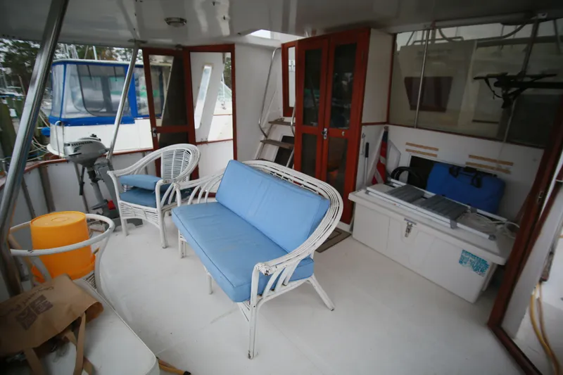 Slide: The Image of 1987 Jefferson 42 Sundeck Motor Yacht interior with seating and storage. - 46