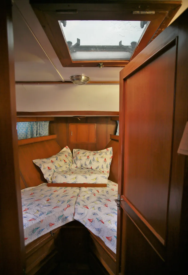Slide: The Image of Cozy cabin interior of 1987 Jefferson 42 Sundeck Motor Yacht with nautical-themed bedding. - 48
