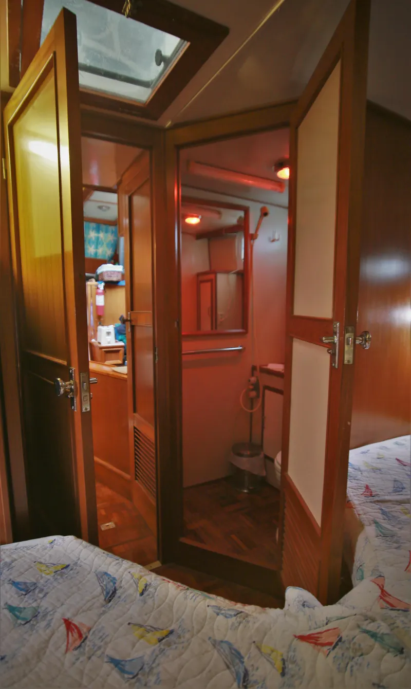 Slide: The Image of 1987 Jefferson 42 Sundeck Motor Yacht interior with wooden doors and cozy cabin. - 49