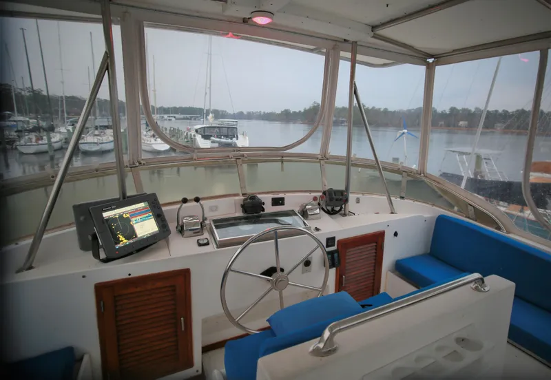 Slide: The Image of 1987 Jefferson 42 Sundeck Motor Yacht helm with navigation system, docked at marina. - 5