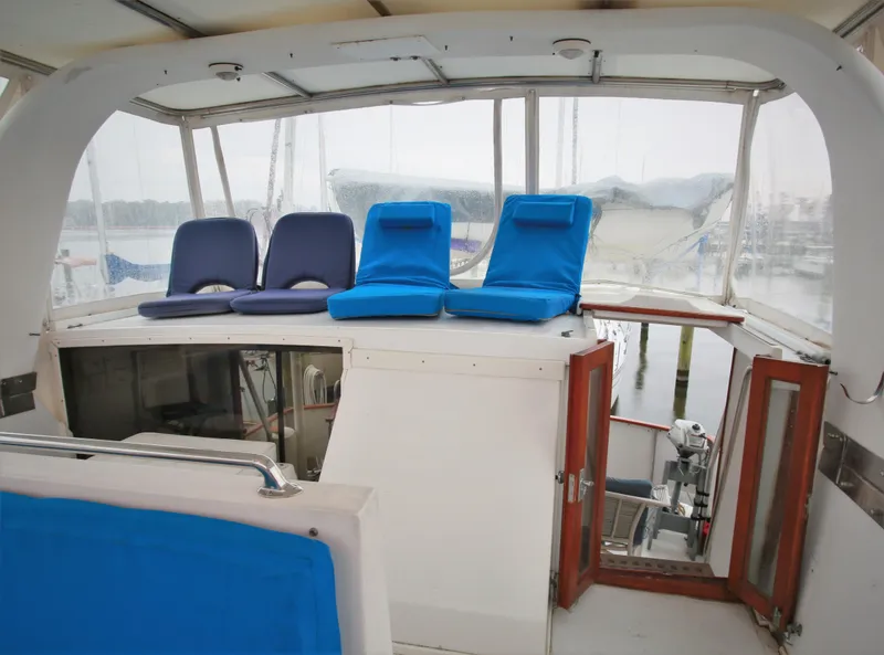 Slide: The Image of 1987 Jefferson 42 Sundeck Motor Yacht upper deck with blue seating. - 8