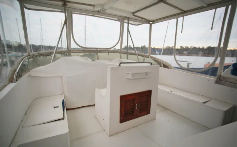Slide: The Image of 1987 Jefferson 42 Sundeck Motor Yacht interior helm station with seating and storage. - 9