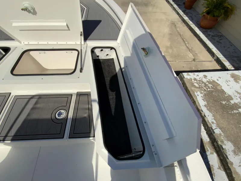 Slide: The Image of 2023 Avid 21 Mag boat storage compartments and deck view. - 10