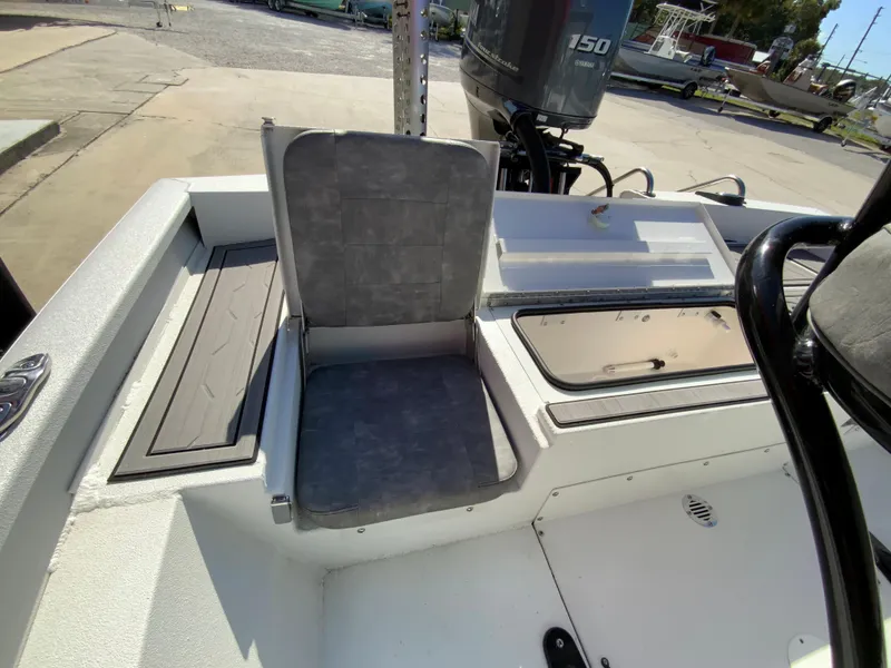 Slide: The Image of 2023 Avid 21 Mag boat interior with seating and outboard motor. - 17