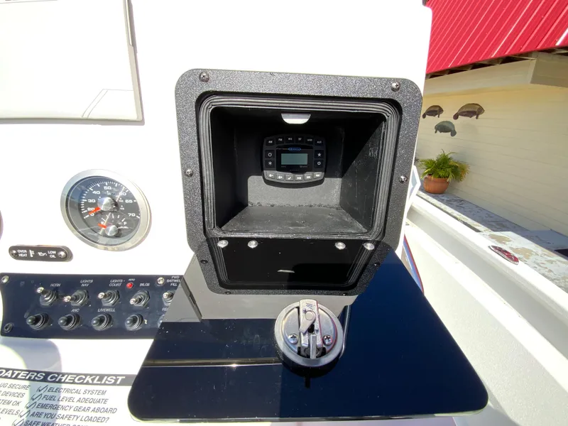 Slide: The Image of Control panel of 2023 Avid 21 Mag boat with gauges and storage compartment. - 18
