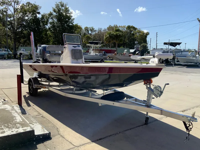 Slide: The Image of 2023 Avid 21 Mag boat on a trailer in a marina parking lot. - 3