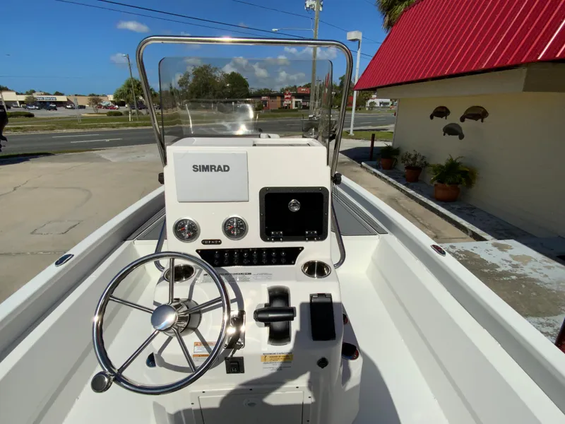 Slide: The Image of 2023 Avid 21 Mag boat console with Simrad electronics and steering wheel. - 6