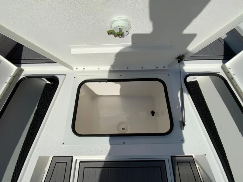 Slide: The Image of 2023 Avid 21 Mag boat storage compartment with open hatch. - 9
