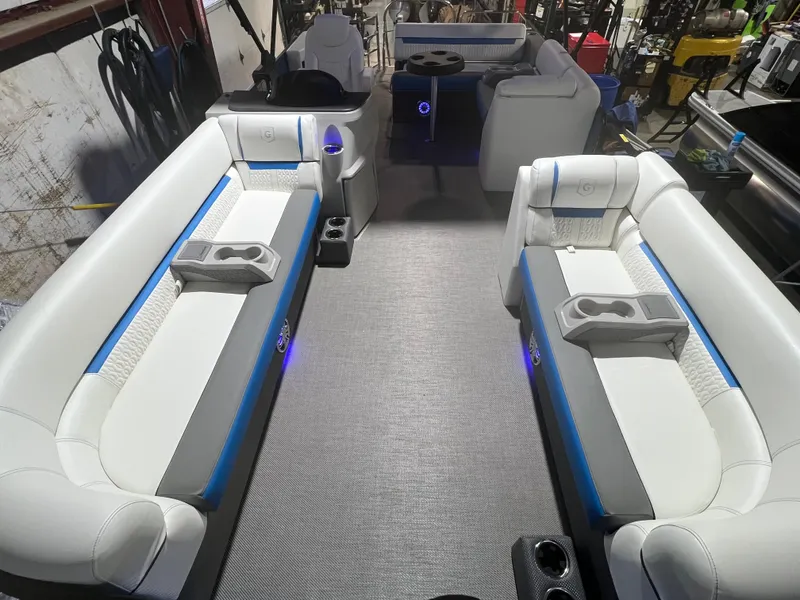 Slide: The Image of 2023 Godfrey SWEETWATER 2286 SFL pontoon boat interior with white seating and blue accents. - 2