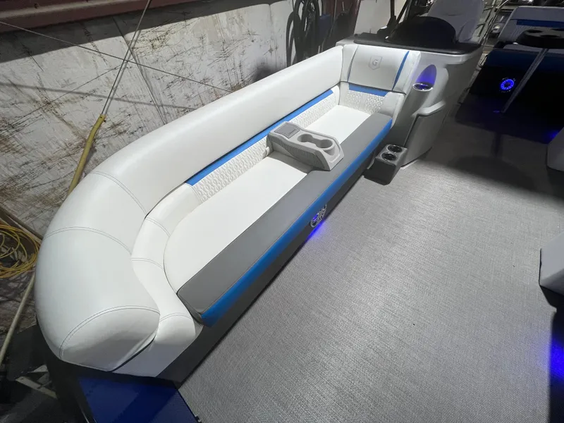 Slide: The Image of 2023 Godfrey SWEETWATER 2286 SFL boat interior with white seating and cup holders. - 3