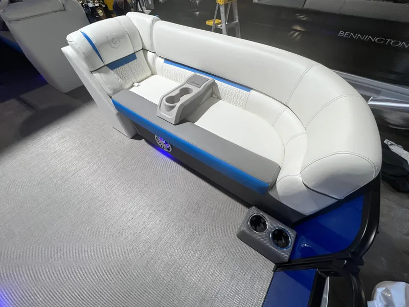 Slide: The Image of 2023 Godfrey SWEETWATER 2286 SFL boat interior with white seating and cup holders. - 4