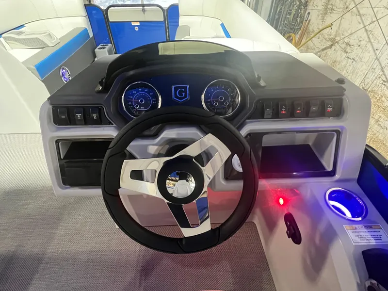 Slide: The Image of 2023 Godfrey SWEETWATER 2286 SFL boat dashboard with steering wheel and controls. - 6