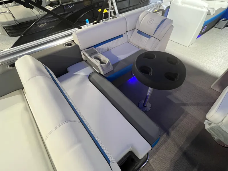 Slide: The Image of 2023 Godfrey SWEETWATER 2286 SFL interior with seating and cupholder table. - 7