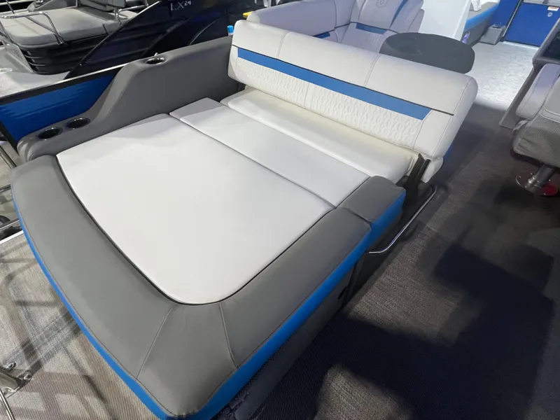 Slide: The Image of 2023 Godfrey SWEETWATER 2286 SFL boat interior with gray and blue seating. - 8