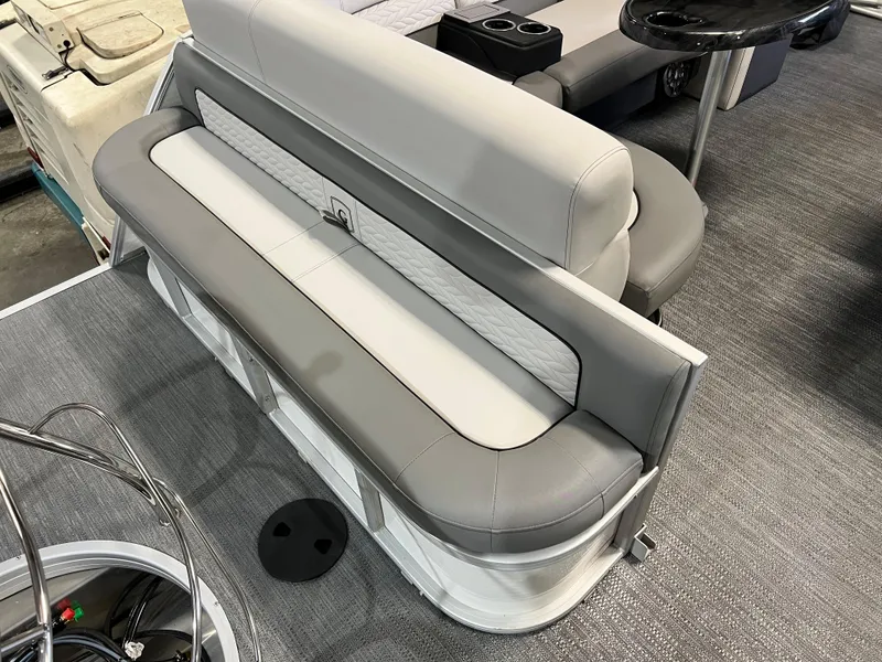 Slide: The Image of 2023 Godfrey Monaco MC215C boat interior with gray seating and carpeted flooring. - 11
