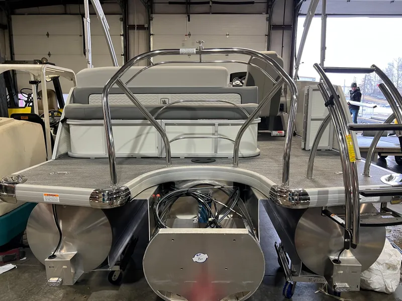 Slide: The Image of 2023 Godfrey Monaco MC215C pontoon boat, rear view in a warehouse setting. - 12