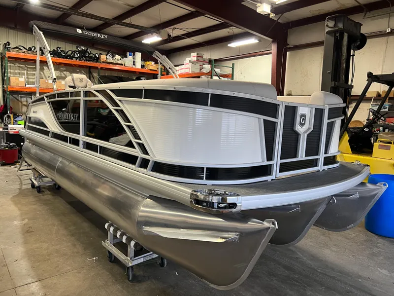 Slide: The Image of 2023 Godfrey Monaco MC215C pontoon boat in a warehouse setting. - 13