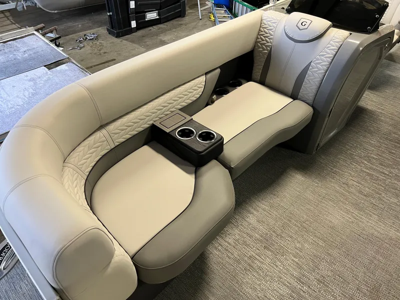 Slide: The Image of 2023 Godfrey Monaco MC215C boat seating with cup holders, featuring elegant beige upholstery. - 5