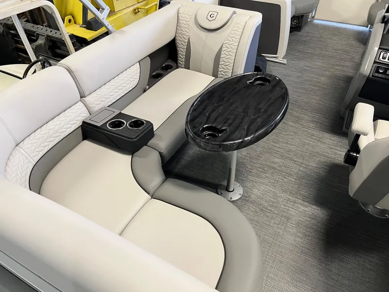 Slide: The Image of 2023 Godfrey Monaco MC215C interior with plush seating and sleek black table. - 7