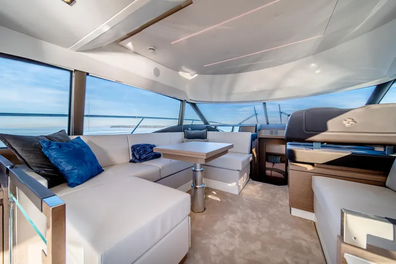 Slide: The Image of Luxurious interior of 2024 Prestige 460 yacht with panoramic windows and plush seating. - 11