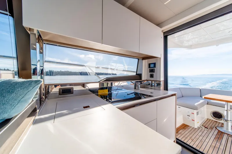 Slide: The Image of Modern kitchen area on the 2024 Prestige 460 yacht with ocean view. - 12