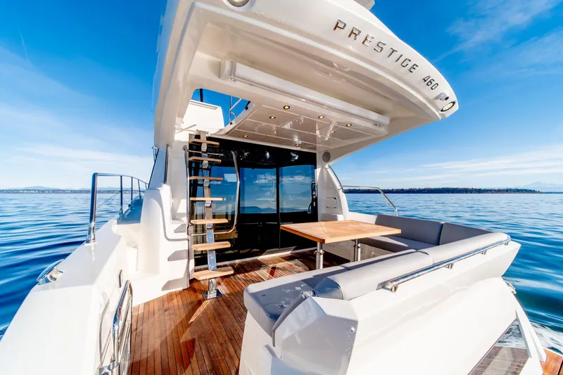 Slide: The Image of 2024 Prestige 460 yacht with outdoor seating and ocean view. - 21