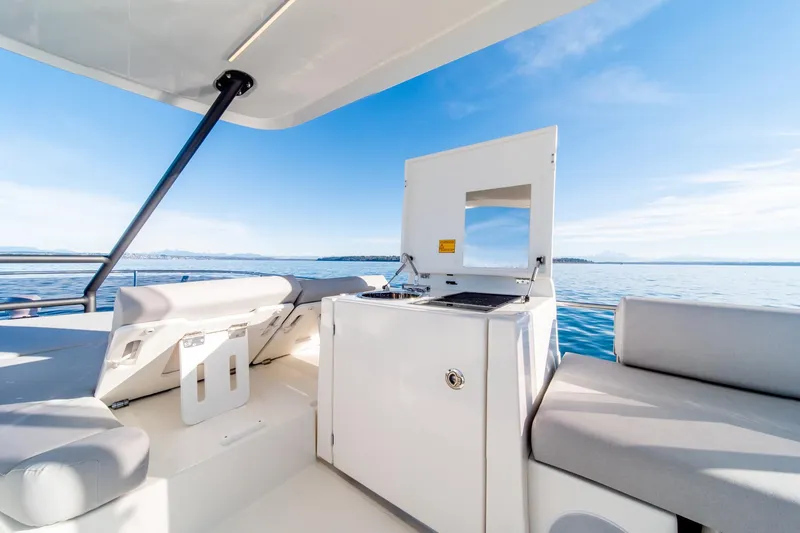 Slide: The Image of Prestige 460 yacht 2024 model, featuring a sleek outdoor kitchen and seating area. - 25