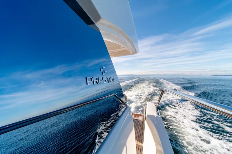 Slide: The Image of 2024 Prestige 460 yacht cruising on open water. - 5