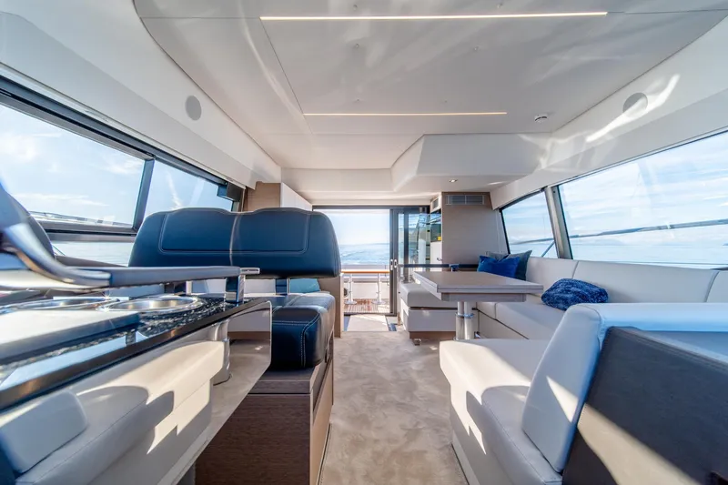 Slide: The Image of Interior of 2024 Prestige 460 yacht with modern seating and panoramic windows. - 8