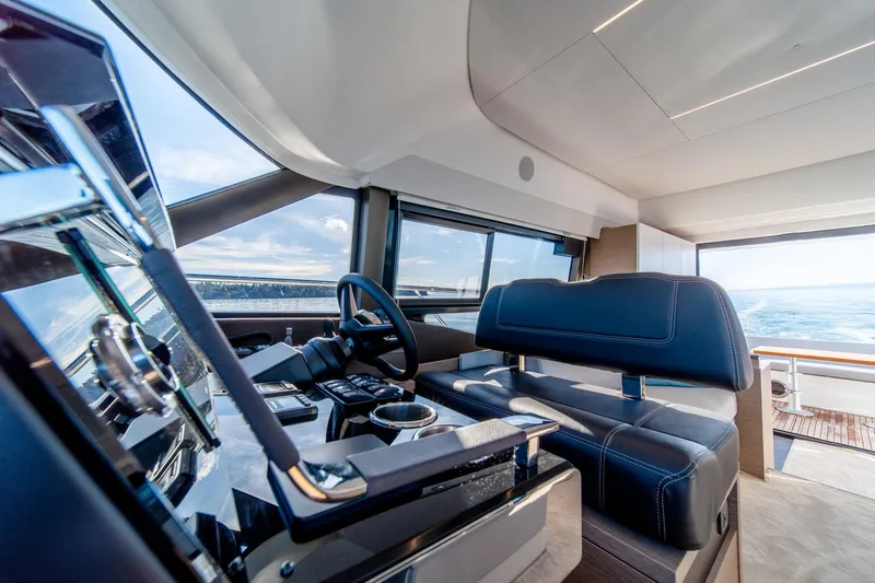 Slide: The Image of Interior of 2024 Prestige 460 yacht, featuring modern helm and luxurious seating. - 9
