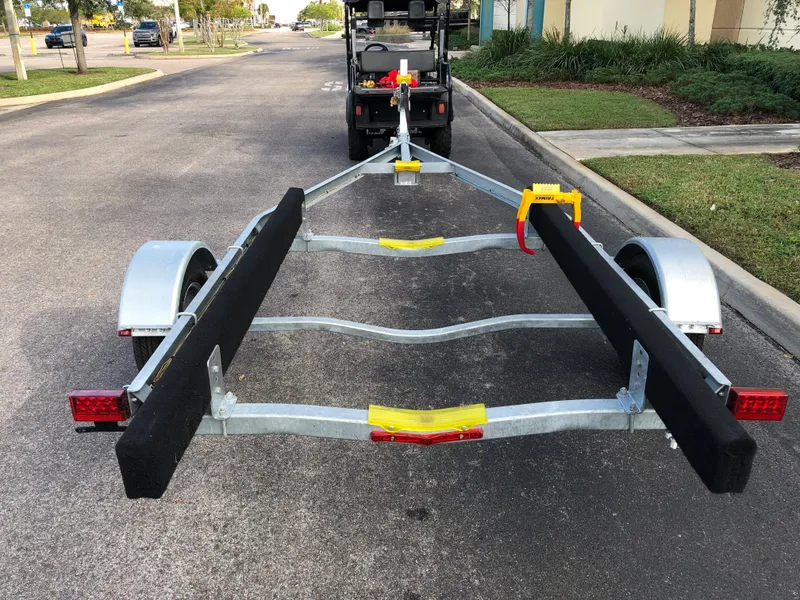 Slide: The Image of Continental Trailers Blazer 1928 boat trailer, 2023 model, parked on a suburban street. - 2