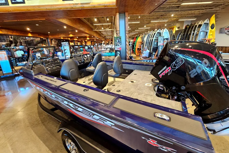 Slide: The Image of 2023 Tracker Targa V-18 WT boat on display in a showroom. - 2