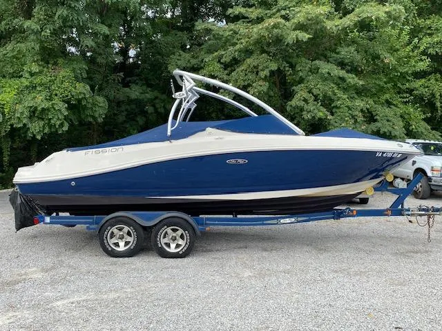 The Image of 2008 Sea Ray 230 Select Fission boat on trailer, blue and white, side view. - 0