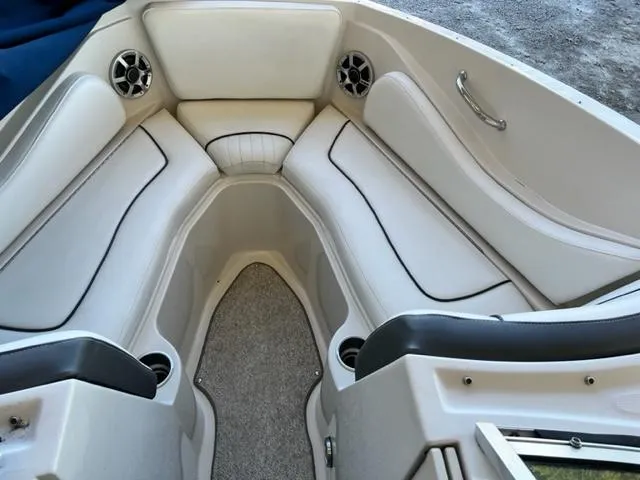 Slide: The Image of 2008 Sea Ray 230 Select Fission boat interior with white cushioned seating. - 11