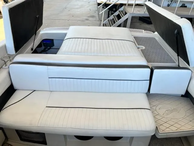 Slide: The Image of 2008 Sea Ray 230 Select Fission boat interior with white cushioned seating. - 12