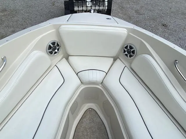 Slide: The Image of 2008 Sea Ray 230 Select Fission boat with white cushioned seating and built-in speakers. - 19