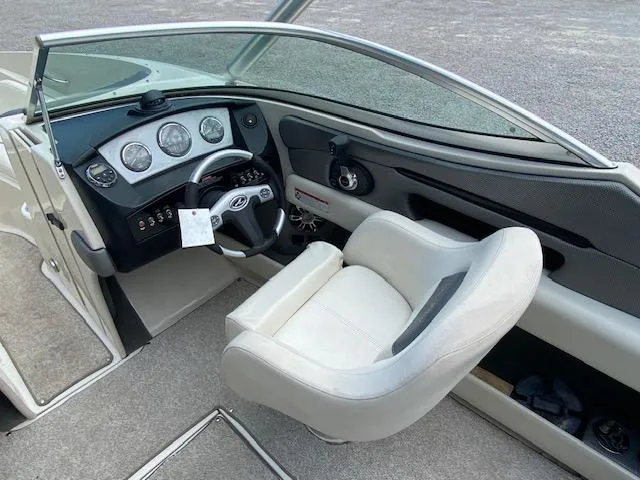 Slide: The Image of 2008 Sea Ray 230 Select Fission boat cockpit with steering wheel and captain's chair. - 23