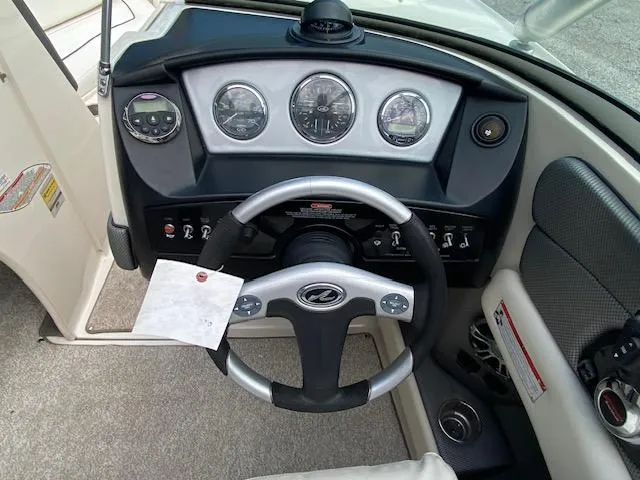 Slide: The Image of 2008 Sea Ray 230 Select Fission boat dashboard with steering wheel and gauges. - 25