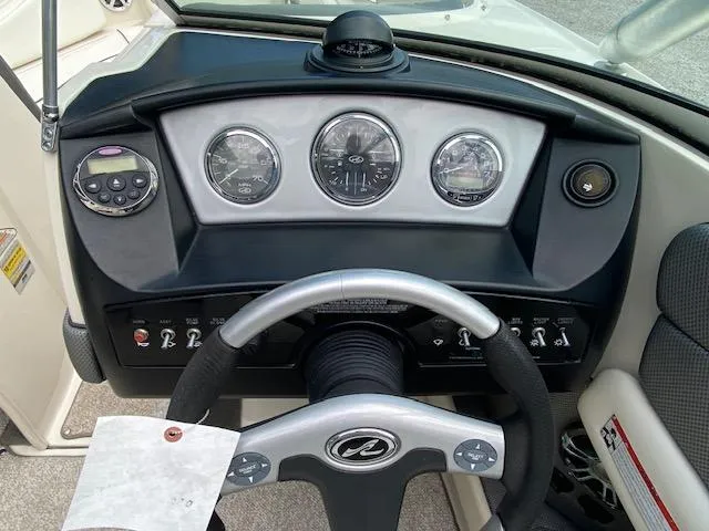 Slide: The Image of 2008 Sea Ray 230 Select Fission boat dashboard with steering wheel and gauges. - 27