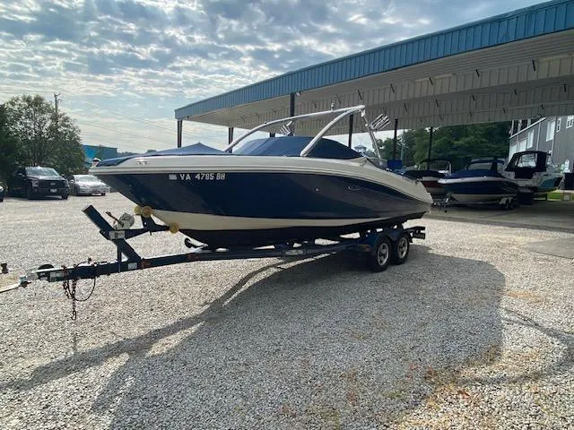 Slide: The Image of 2008 Sea Ray 230 Select Fission boat on a trailer in a parking lot. - 3