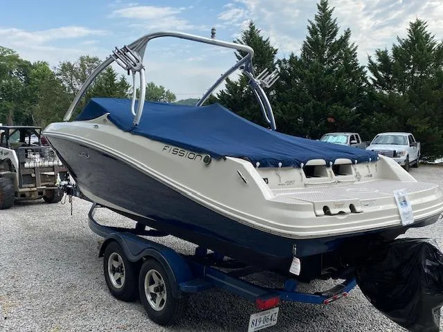Slide: The Image of 2008 Sea Ray 230 Select Fission boat on a trailer, covered and parked outdoors. - 4
