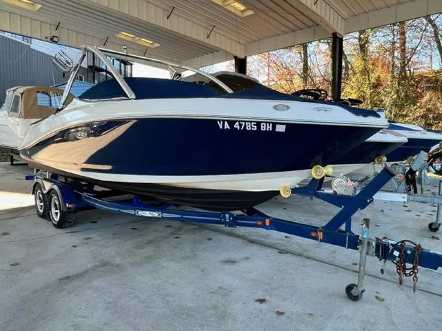 Slide: The Image of 2008 Sea Ray 230 Select Fission boat on a trailer in a covered storage area. - 6