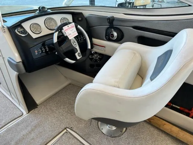 Slide: The Image of 2008 Sea Ray 230 Select Fission boat cockpit with steering wheel and captain's chair. - 8