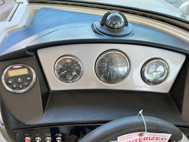 Slide: The Image of 2008 Sea Ray 230 Select Fission dashboard with gauges and compass. - 9