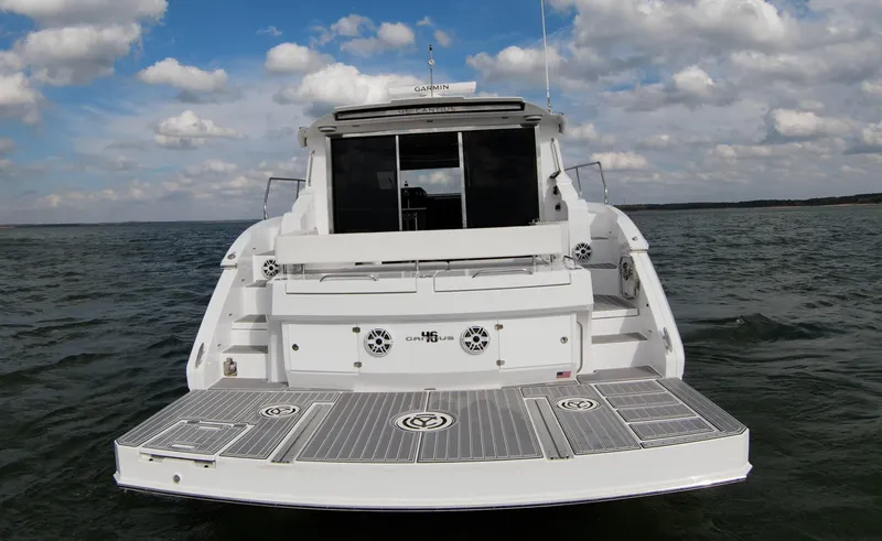 Slide: The Image of 2020 Cruisers Yachts 460 Cantius, rear view on water with swim platform. - 11