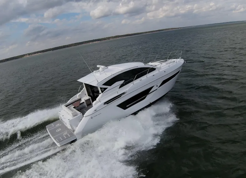 Slide: The Image of 2020 Cruisers Yachts 460 Cantius cruising on open water. - 2