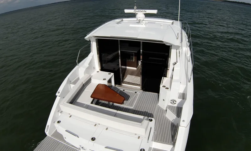 Slide: The Image of 2020 Cruisers Yachts 460 Cantius, rear deck view on the water. - 20