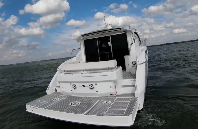 Slide: The Image of 2020 Cruisers Yachts 460 Cantius on open water under a partly cloudy sky. - 21