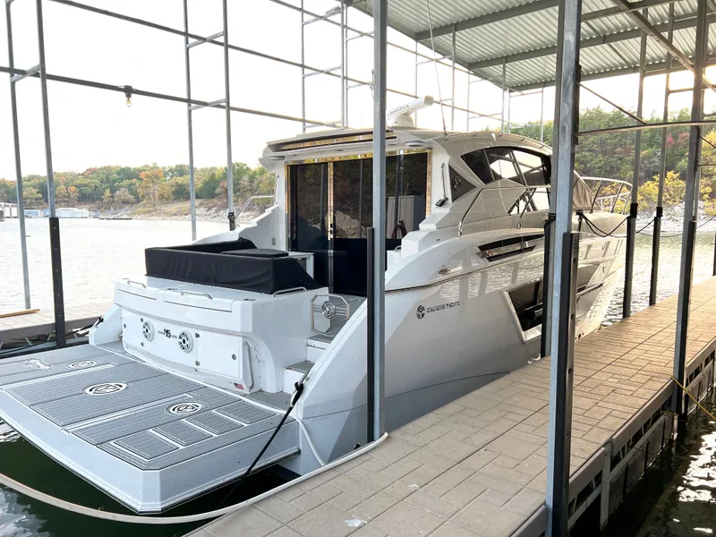Slide: The Image of 2020 Cruisers Yachts 460 Cantius docked in a covered marina. - 23