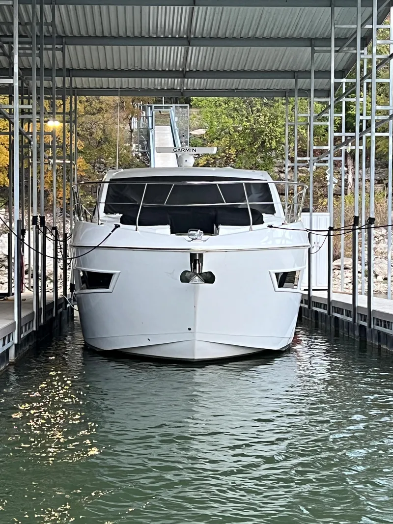 Slide: The Image of 2020 Cruisers Yachts 460 Cantius docked in a covered marina. - 27